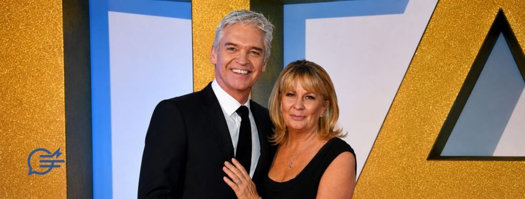 Stephanie Lowe and her husband Phillip Schofield smiling together at a red carpet event.